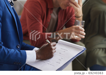 Therapist Taking Notes in Session 69240363