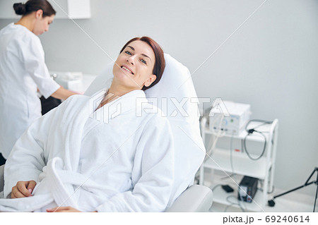 Pleased lady waiting for a beauty procedure Pleased lady waiting for a beauty procedure 69240614