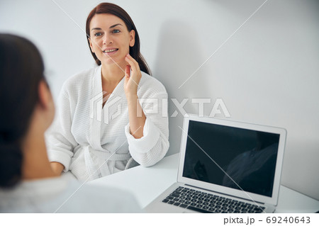 Smiling woman listening attentively to a doctor 69240643
