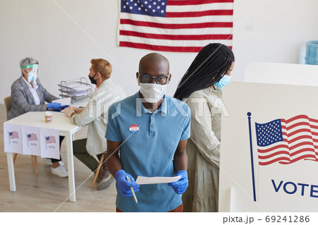 People Wearing PPE at Voting Station People Wearing PPE at Voting Station 69241286