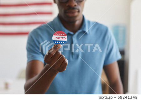 African-American Man Holding I VOTED Sticker African-American Man Holding I VOTED Sticker 69241348