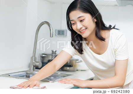 Woman housecleaning Woman housecleaning 69242380