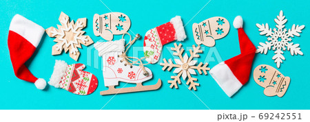 Top view Banner of Christmas decorations and Santa hats on blue background. Happy holiday concept with copy space Top view Banner of Christmas decorations and Santa hats on blue background. Happy holiday concept with copy space 69242551