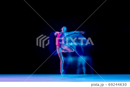 Young and graceful ballet dancer isolated on black studio background in neon mixed light Young and graceful ballet dancer isolated on black studio background in neon mixed light 69244630