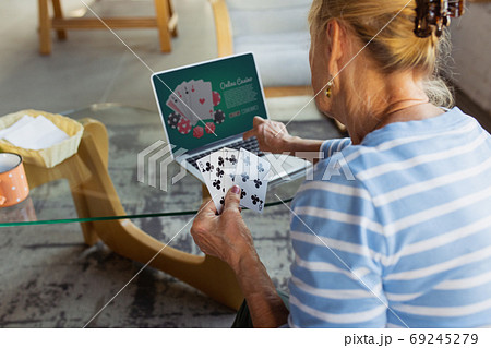 Senior woman studying at home, getting online courses Senior woman studying at home, getting online courses 69245279