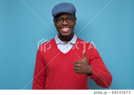 african man with cheerful facial emotion showing thumb up african man with cheerful facial emotion showing thumb up 69245673