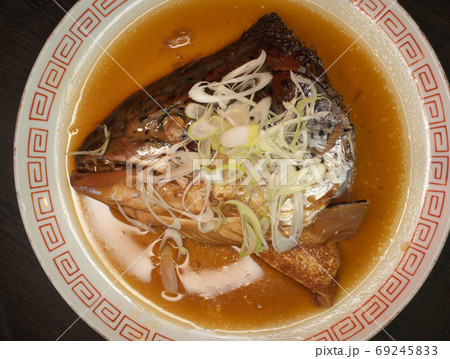 Salmon head steamed soy sauce and vegetable n dish.  69245833