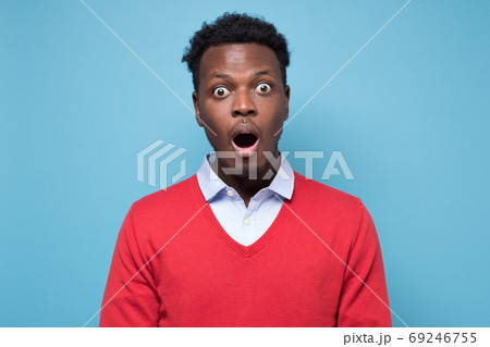 Handsome african man looking in shock and frustration at the camera Handsome african man looking in shock and frustration at the camera 69246755