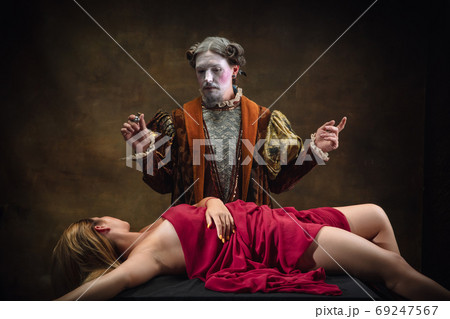 Young man as Johann Sebastian Bach on dark green background. Retro style, comparison of eras concept. 69247567