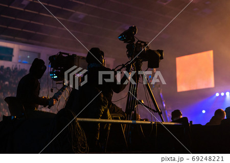Silhouette of a group of cameramen broadcasting an event. Silhouette of a group of cameramen broadcasting an event. 69248221