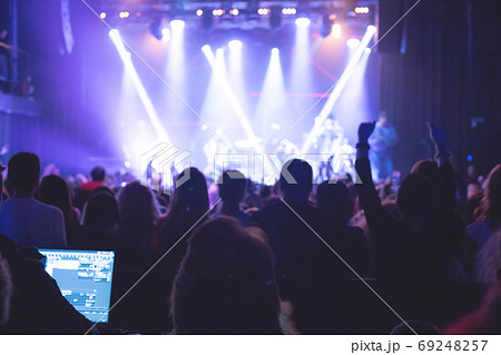 The audience watching the concert on stage. 69248257