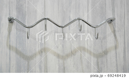 Metal adhesive hooks on gray background Metal adhesive hooks on gray background 69248419