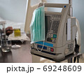 Surgical mask is placed on the medical device. With the patient in the room. 69248609