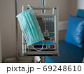Surgical mask is placed on the medical device. With the patient in the room. 69248610