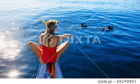 Young girl on dolphins watching and snorkeling tour 69249807