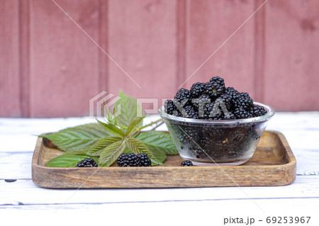 Fresh and sweet blackberry with leaves on the wooden background. Fresh and sweet blackberry with leaves on the wooden background. 69253967