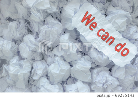 The word  WE CAN DO  is placed on the background paper in the big trash. 69255143