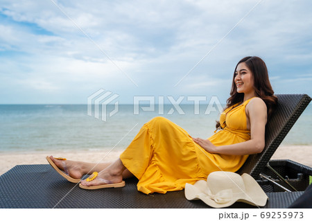 woman relaxing on a chair in Hua Hin beach, Thailand 69255973