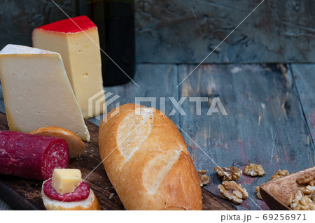 exquisite rustic table with various cheeses, salami and fresh bread 69256971