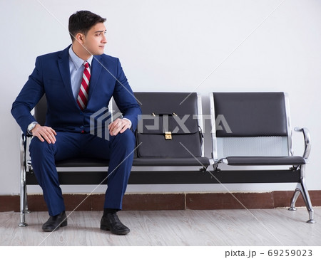 Man wairing to boarding in airport lounge room Man wairing to boarding in airport lounge room 69259023