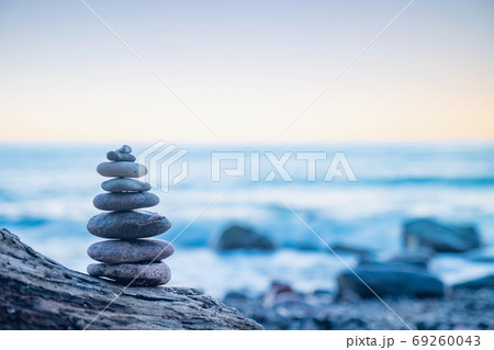 Stones pebbles stacked in a Zen pyramid on sea coast Stones pebbles stacked in a Zen pyramid on sea coast 69260043