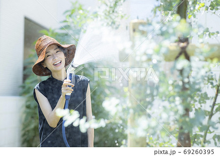 女性 家庭菜園 水やりの写真素材