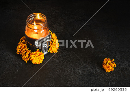 Skull with marigold flowers wreath on black 69260536