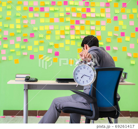 Businessman with many conflicting priorities in time management 69261417