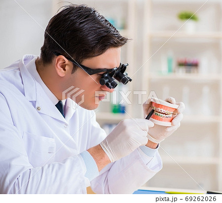 Young dentist working in the dentistry hospital Young dentist working in the dentistry hospital 69262026