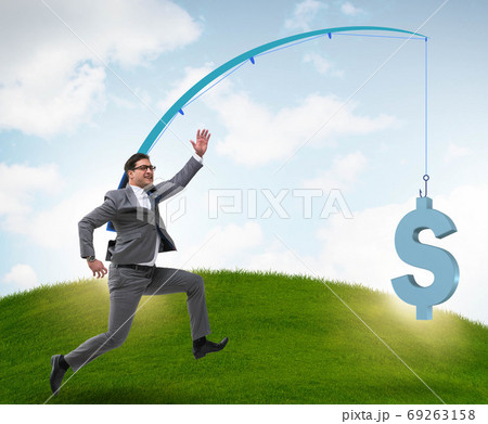 Businessman chasing money on fishing rod 69263158