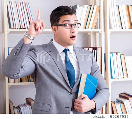 The businessman student reading a book studying in library The businessman student reading a book studying in library 69267955