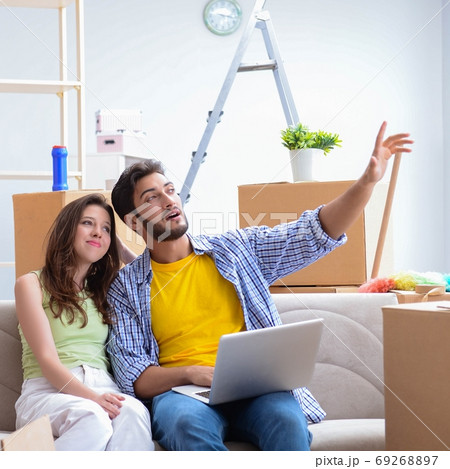 Young family discussing relocation at home Young family discussing relocation at home 69268897