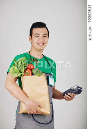 Happy young supermarket worker Happy young supermarket worker 69269315