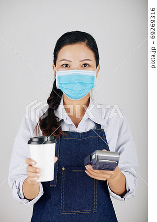 Barista giving payment terminal and order Barista giving payment terminal and order 69269316
