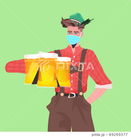 man in medical mask holding beer mugs Oktoberfest party celebration coronavirus quarantine concept man in medical mask holding beer mugs Oktoberfest party celebration coronavirus quarantine concept 69269377
