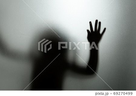 Ghost concept shadow of a child behind the matte glass blurry ha 69270499