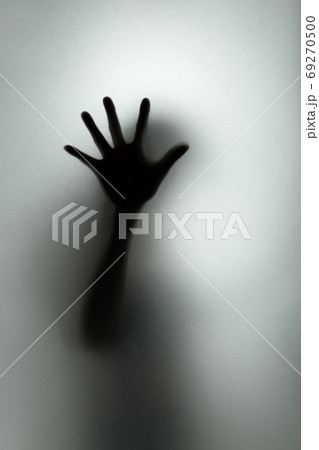 Ghost concept shadow of a woman behind the matte glass blurry ha 69270500