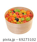 Assorted candied fruits in a wooden pot on a white background 69273102