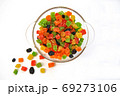 Assorted candied fruits in a glass dish on a white background 69273106