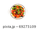 Assorted candied fruits in a glass dish on a white background 69273109