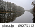 autumn river in the fog and trees without leaves 69273112