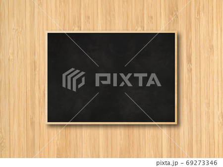 Traditional black board isolated on a wooden background 69273346