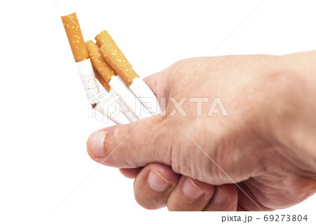 Addiction. Closeup of the broken cigarettes on man hand. Quit smoking Addiction. Closeup of the broken cigarettes on man hand. Quit smoking 69273804