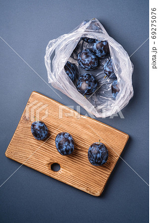 Fresh ripe plum fruits in plastic bag package Fresh ripe plum fruits in plastic bag package 69275076