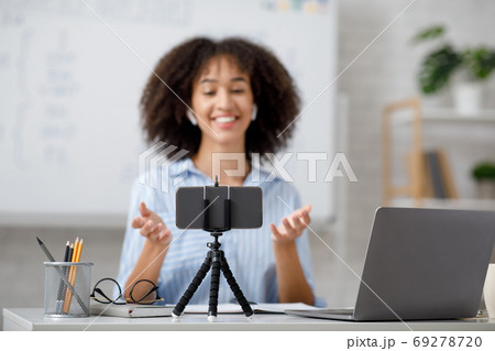 Educational training in class and lecture online. Tutor look at webcam in interior of living room 69278720