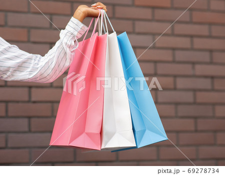 Discount store. African american female hand with colored shopping bags 69278734