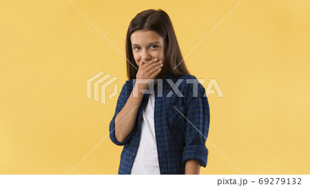 Beautiful girl laughing covering mouth with hand 69279132