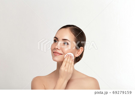 Woman Cleaning Face With White Pad. Woman Cleaning Face With White Pad. 69279159