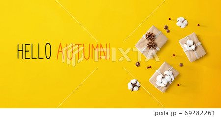 Hello autumn message with gift boxes with cottons Hello autumn message with gift boxes with cottons 69282261