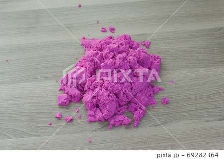 bright pink kinetic sand in the hands of a child. Development and education. Fine motor skills 69282364